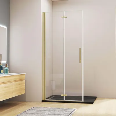 A modern bathroom with a gold-framed glass shower enclosure.