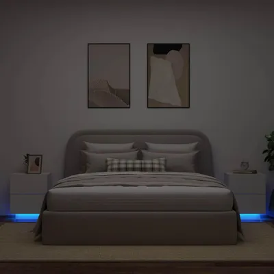 A bedroom scene with a bed, nightstands, and artwork on the wall.