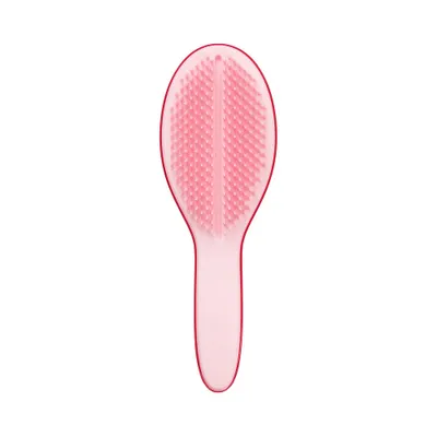 A pink hairbrush is shown against a white background.