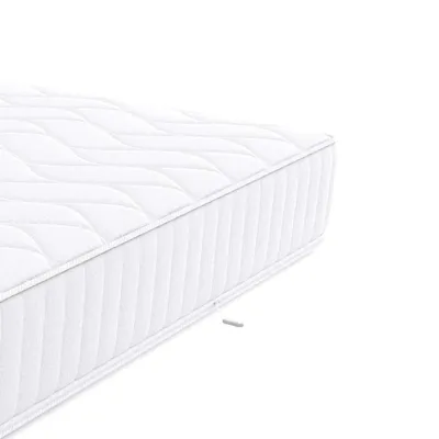 A close-up view of a white mattress on a white background.