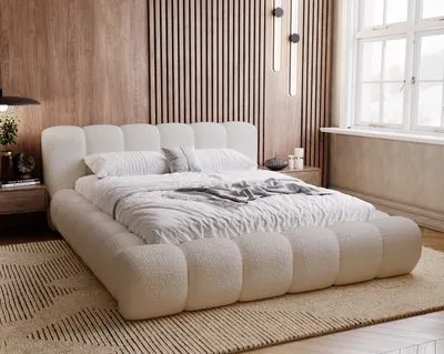 A bedroom scene featuring a plush boucle bed.