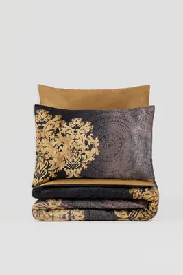 A neatly folded duvet set and pillowcase are displayed against a white background.