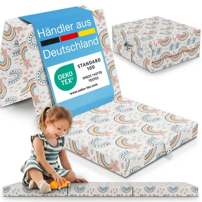 A child playing with a folded mattress that has a rainbow pattern. The mattress is shown in a folded state and unfolded.