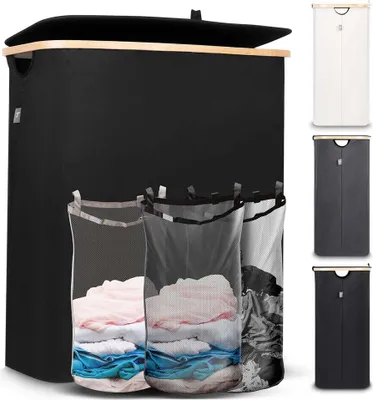 A black laundry basket with a wooden lid and three mesh laundry bags filled with clothes. Several other laundry baskets in different colors are shown on the right side of the image.