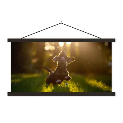 Produktbild von MuchoWow® Textilposter Welpe läuft im Gras 150x75 cm mit schwarzem Rahmen - Posterleiste