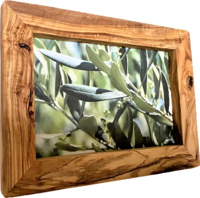 A wooden picture frame with a picture of olive leaves inside.