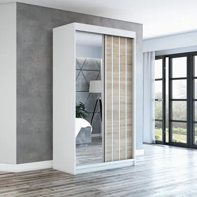 A modern bedroom with a sliding door wardrobe.