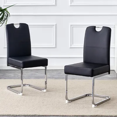 Image de Un ensemble de deux chaises de salle à manger noires, aux lignes épaisses, dotées d'un système de suspension intégré et d'un design ergonomique : un mélange parfait de confort et d'élégance. Noir