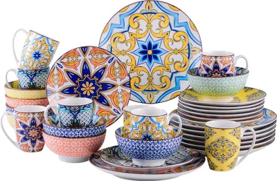A collection of ceramic dinnerware with a colorful, intricate pattern.