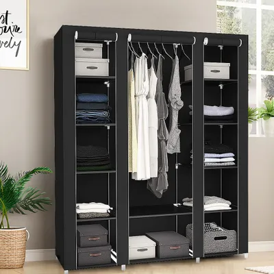 A black fabric wardrobe with clothing and storage boxes.