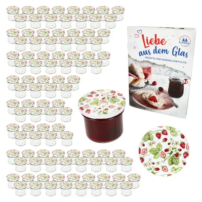 A collection of small glass jars with strawberry-themed lids, a jar filled with jam, and a recipe book about making preserves.