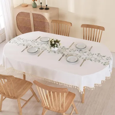 Zdjęcie produktu dla Owalna obrus, 140x220 cm, beżowy, z haftowanymi zielonymi liśćmi i frędzlami