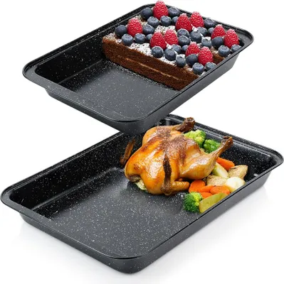 Two baking trays, one with a cake and berries, the other with a roasted chicken and vegetables.