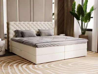 A bedroom scene featuring a large, tufted bed.