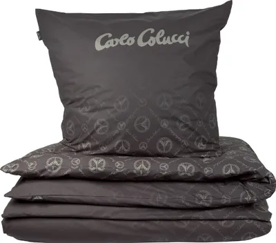 A stack of folded bedding, including a pillowcase and duvet cover, with a repeating peace sign pattern.