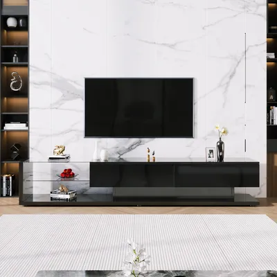 A modern living room with a TV stand and a large television mounted on a marble-patterned wall.
