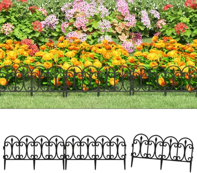 A black decorative garden border fence in front of a flower bed.