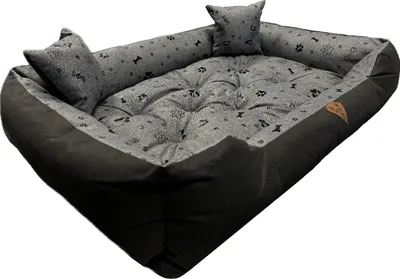 A dog bed with a patterned interior and solid dark exterior.