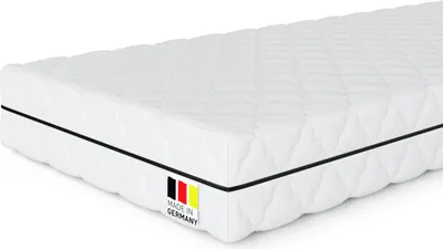 A white mattress with a black stripe and a "Made in Germany" label.