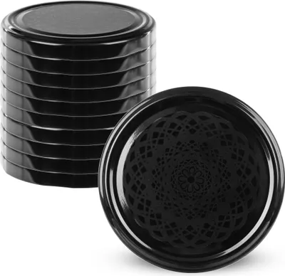 A stack of black jar lids and one lid shown separately with a decorative pattern.