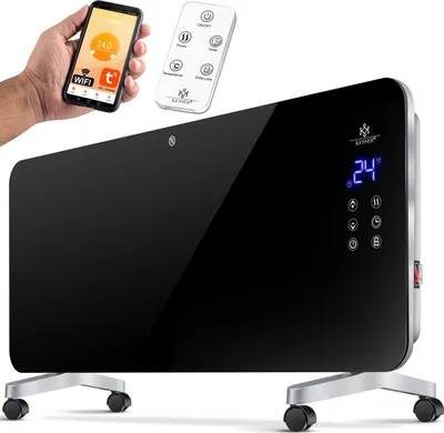 A hand holds a smartphone displaying a heating app next to a remote control, with a sleek black glass electric heater in the foreground.