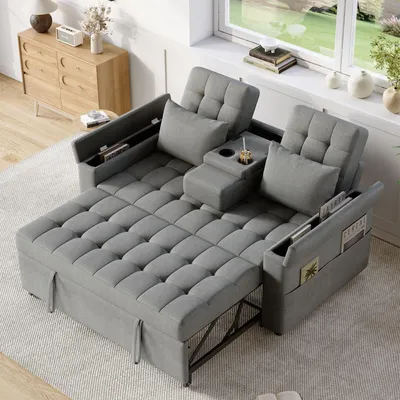 A gray sofa bed is shown in a living room setting with a window and a dresser in the background.