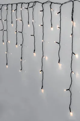 A string of LED lights hanging against a light gray wall.