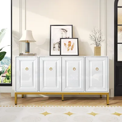 A white sideboard with gold accents is displayed in a well-lit room, decorated with framed pictures and a lamp.