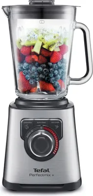 A blender filled with fruits is shown against a white background.