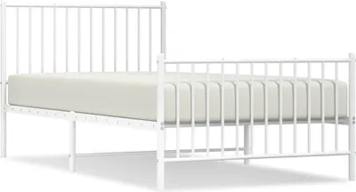 A white metal bed frame with a mattress.