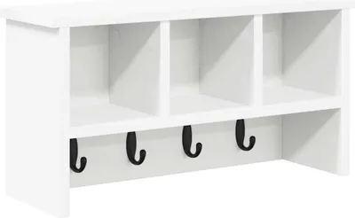 A white wall-mounted coat rack with three cubbies and five black hooks.