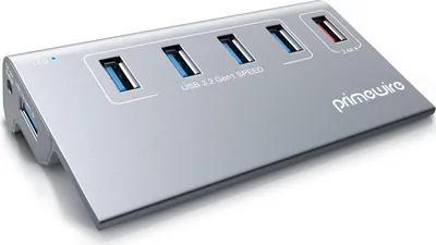 A silver USB hub with multiple ports is shown on a white background.
