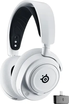 A white SteelSeries ARCTIS NOVA 7X gaming headset with a black headband interior and a small USB dongle.