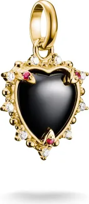 A gold charm in the shape of a heart with a black stone, surrounded by small red and white stones and snake-like figures.
