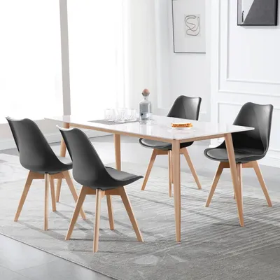 A dining table with four chairs in a well-lit room.