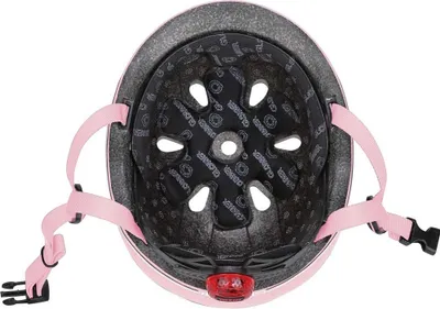 The inside of a child's helmet with pink straps and a red light on the back.
