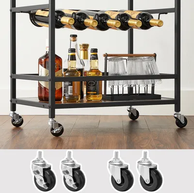 A bar cart filled with bottles and glasses, with a close-up of the casters at the bottom.