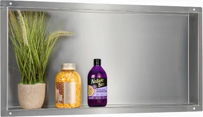 A bathroom shelf containing a potted plant, a jar of bath salts, and a bottle of shower gel.