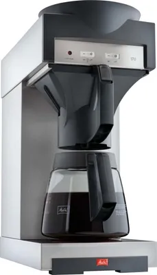 A close-up studio shot of a silver and black coffee maker with a glass carafe filled with coffee.