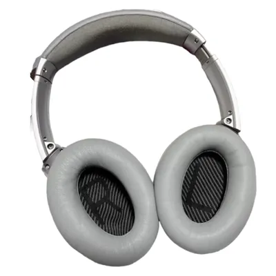 A pair of gray over-ear headphones on a white background.