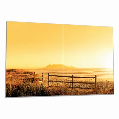 Produktbild von Wallario Herdabdeckplatte aus Glas, Größe 80 x 52 cm 2-teilig, Motiv Strand in Südafrika I - Himmel in orange