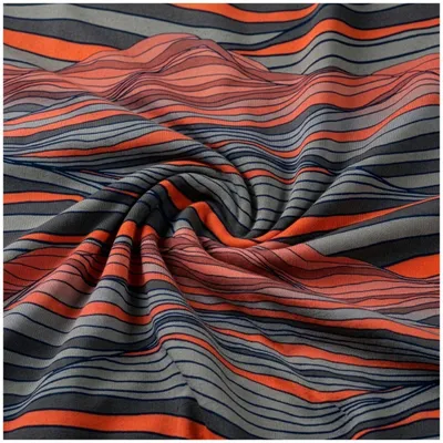 Thorsten Berger Jersey-Stoff In the Dunes Kombistoff künstlerisch drapiert mit Wellen-Design in Orange, Grau und Anthrazit.