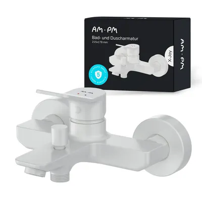 A white bathroom faucet is shown in front of its packaging.