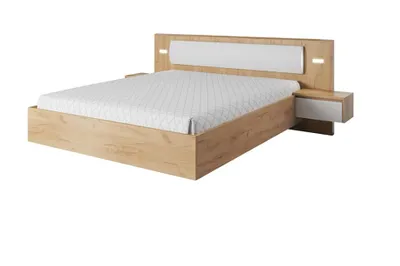 A modern bed with integrated nightstands and a headboard with lighting.