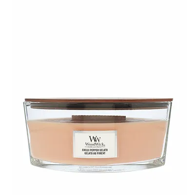 A WoodWick candle in a clear glass jar with a wooden lid.