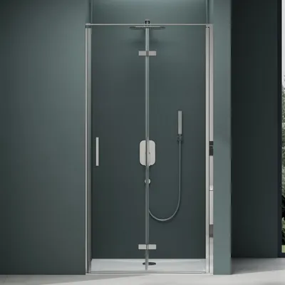 A modern shower enclosure with a glass door and silver hardware against a dark teal wall.