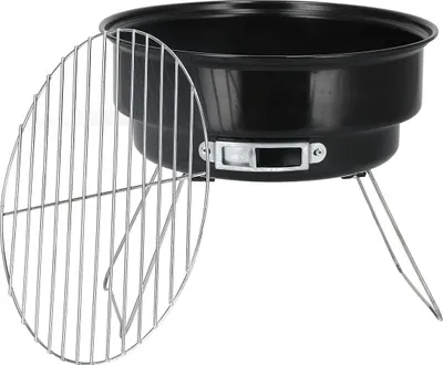 A black portable charcoal grill with a silver grill grate next to it, set against a white background.