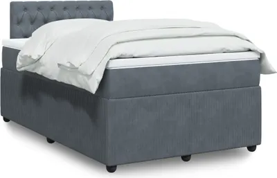 A studio shot of a bed with bedding.