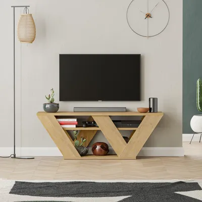A modern living room with a TV stand, TV, and decorative items.