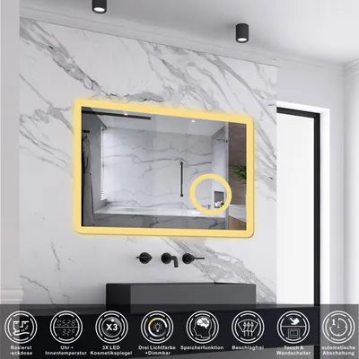 A modern bathroom with a marble wall, a black sink, and a lighted mirror.